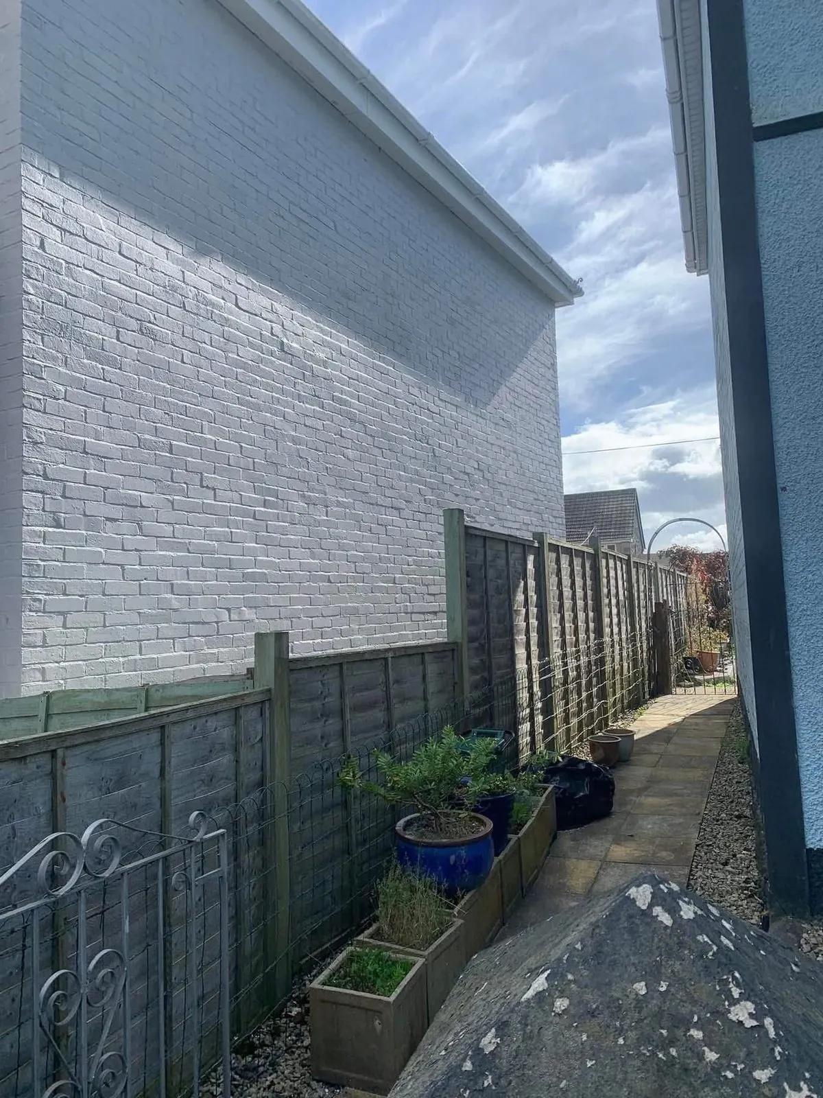 Freshly painted brick wall after preparation and masonry paint in Plymouth